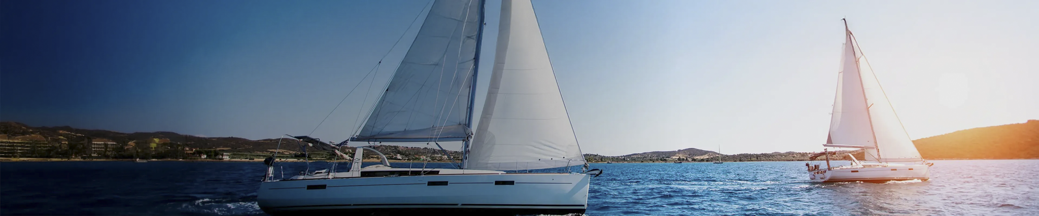 Sailing yachts on blue water in sunshine