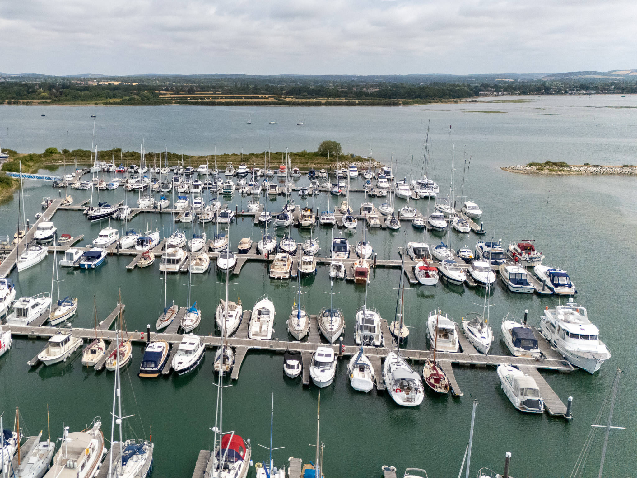 An aerial view of a marina and surrounding coastal waters